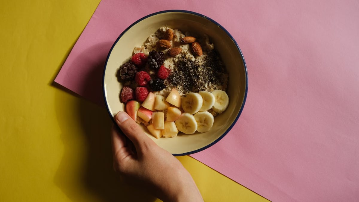 Delicious oatmeal bowl with fresh fruits and nuts, perfect for a healthy breakfast.